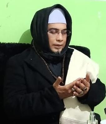 Pengasuh sedang memimpin doa dengan tasbih